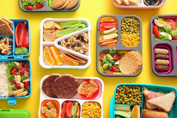 Many Lunchboxes Different Delicious Food Yellow Background — Stock Photo, Image