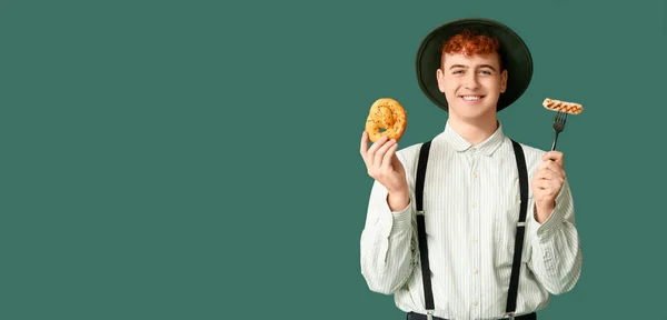 德国男子与椒盐卷饼和香肠绿色背景与文字的空间 十月节的横幅 — 图库照片