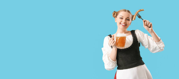 Beautiful Octoberfest waitress with beer and sausage on light blue background with space for text
