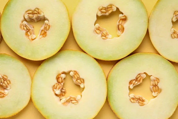 Slices of sweet melon on yellow background