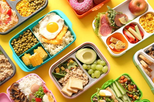 Many Lunchboxes Different Delicious Food Yellow Background — Stock Photo, Image