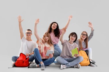 Işık arka planında oturan bir grup öğrenci