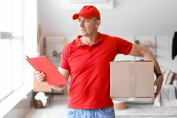 Mature Courier Clipboard Parcel Indoors — Stock Photo, Image