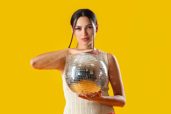 Stylish Young Woman Disco Ball Yellow Background — Stock Photo, Image