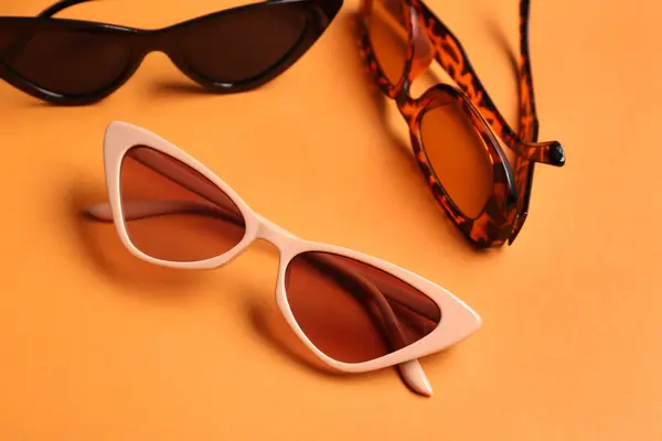 Different Stylish Eyeglasses Orange Background — Stock Photo, Image