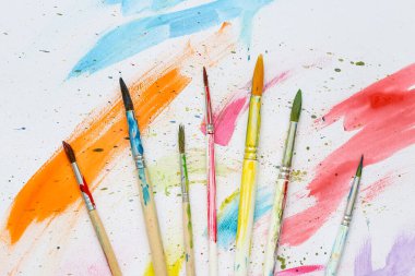 Beyaz arkaplanda sanatçının fırçaları ve boyaları
