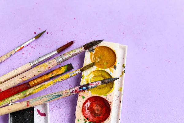 Pincéis Artista Com Tintas Sobre Fundo Lilás — Fotografia de Stock
