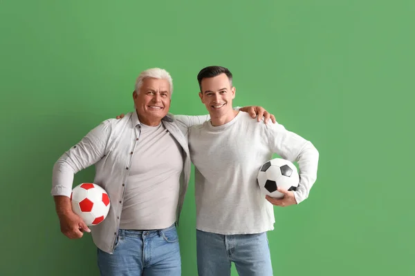 Young Man His Father Soccer Balls Hugging Green Background — Stock Photo, Image