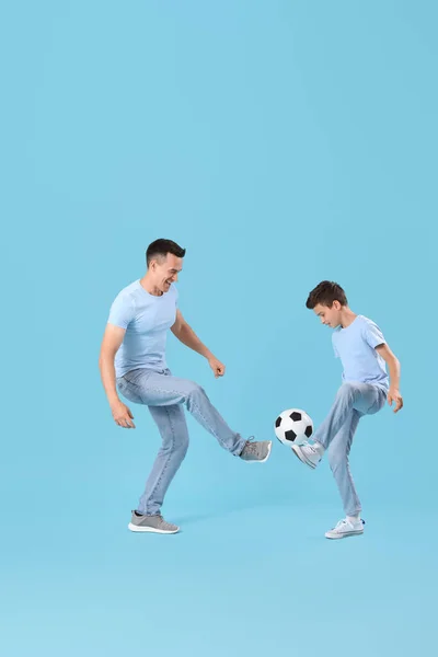 Niño Pequeño Con Padre Jugando Fútbol Sobre Fondo Azul —  Fotos de Stock