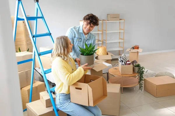 Young couple packing things in bedroom on moving day