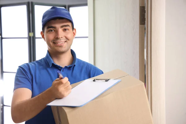Male Courier Parcel Clipboard Indoors — Stock Photo, Image