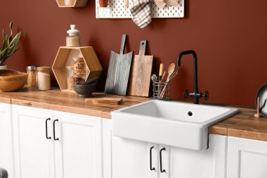 Modern mutfakta lavabolu ahşap tezgah ve çatal bıçak.