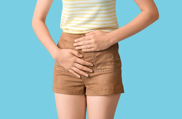 Young Woman Suffering Cystitis Blue Background Closeup — Stock Photo, Image