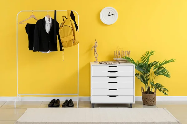 Rack Stylish School Uniform Backpack Yellow Wall Room — Stock Photo, Image