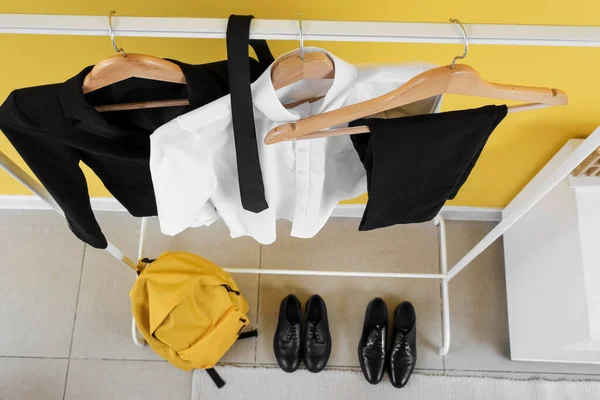 Rack Stylish School Uniform Backpack Yellow Wall Room — Stock Photo, Image