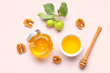 Rosh Hashanah kutlaması için cevizli kavanoz ve bal (Yahudi Yeni Yılı) pembe arka planda