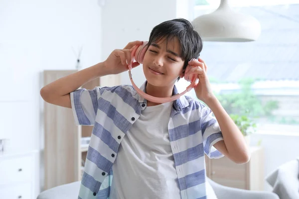 Little boy in headphones dancing at home