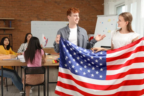 stock image Young students with USA flag at language school