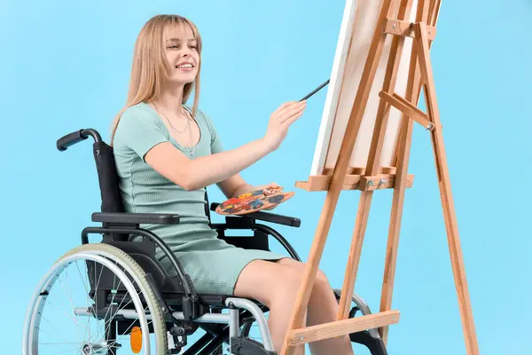 Young Woman Wheelchair Painting Easel Blue Background — Stock Photo, Image