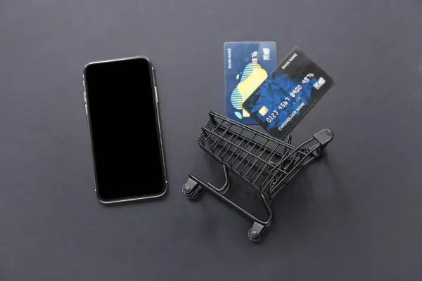 Small Shopping Cart Credit Cards Mobile Phone Black Background — Stock Photo, Image