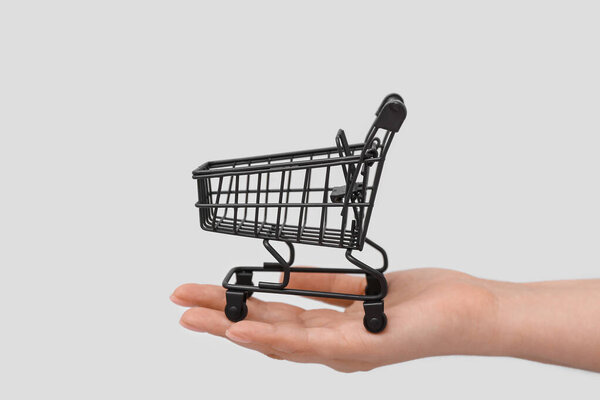 Female Hand Shopping Cart Grey Background — Stock Photo, Image