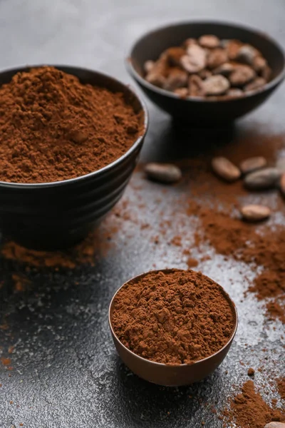 stock image Bowls with cocoa powder on black background