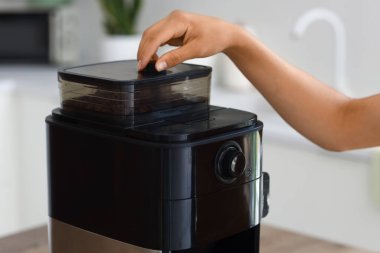 Mutfakta kahve yapan genç bir kadın, yakın plan.