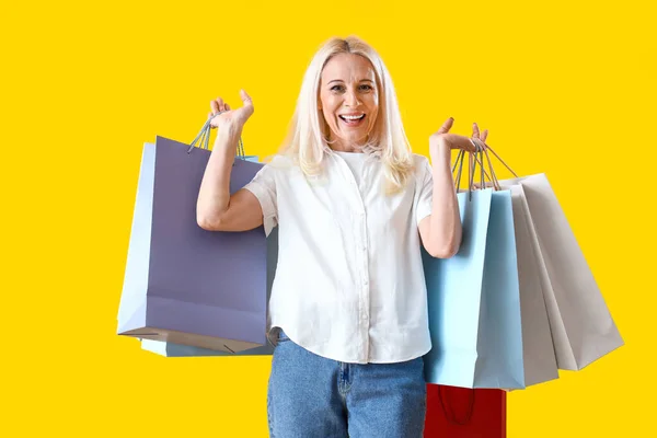 Rijpere Vrouw Met Boodschappentassen Gele Achtergrond — Stockfoto