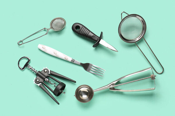 Set of kitchen utensils on turquoise background