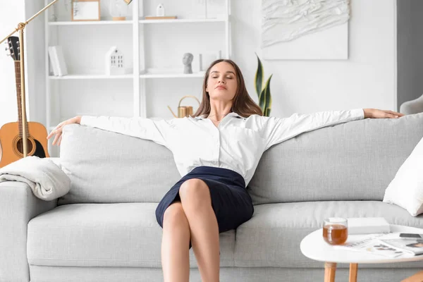 Young businesswoman resting at home after long working day