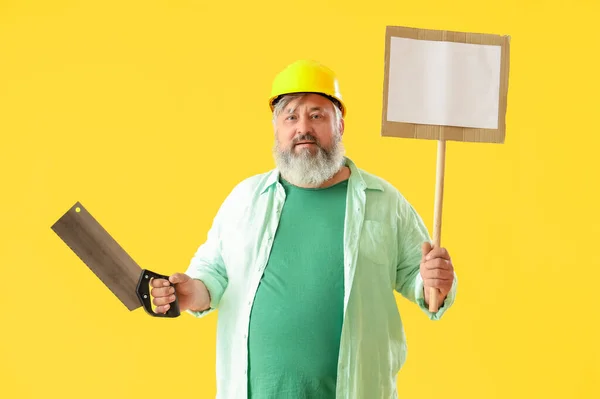 Portrait Senior Man Hardhat Handsaw Blank Sign Yellow Background Labor — Stock Photo, Image