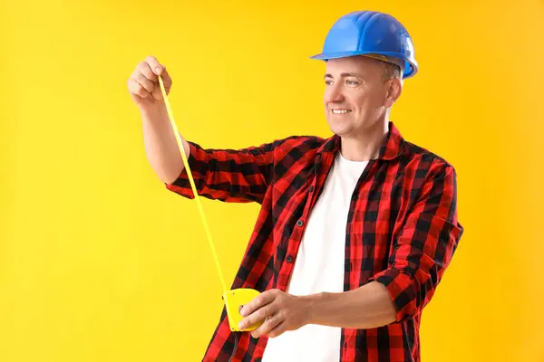 Mature Worker Tape Measure Yellow Background Labor Day Celebration — Stock Photo, Image