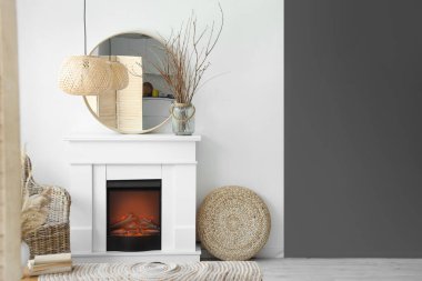 Siyah beyaz duvarın yanında şık bir şömine ve ayna.