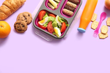 Lezzetli yemekler ve leylak arkaplanda bir şişe meyve suyu.