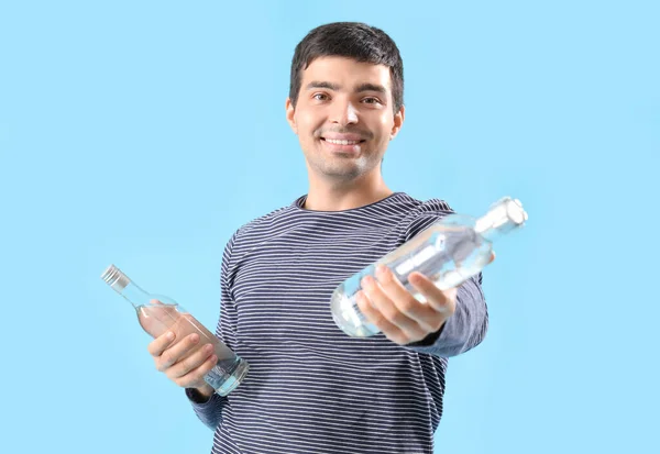 Jeune Homme Avec Des Bouteilles Vodka Sur Fond Bleu — Photo