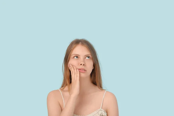 Mavi Arka Planda Diş Ağrısı Çeken Genç Bir Kadın — Stok fotoğraf