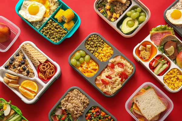Many Lunchboxes Different Delicious Food Red Background — Stock Photo, Image