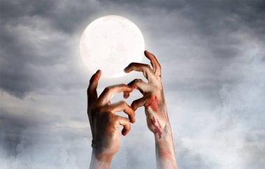 Zombi elleri ve gece gökyüzünde dolunay.