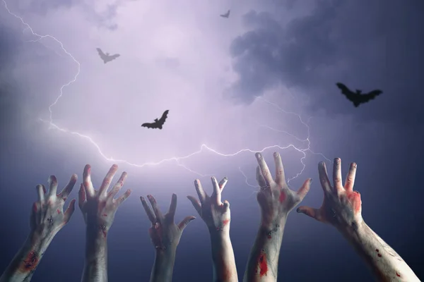 Hands of zombies and lightning in sky