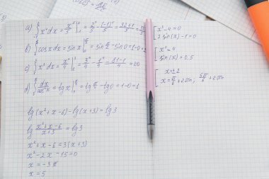 Matematik formülleri ve kalemi arkaplan olarak gösteren bir kopya kitabı aç, kapat