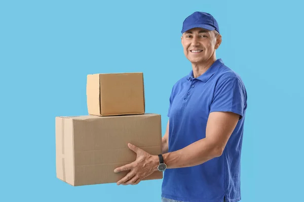 成熟した宅配便ブルーの背景の小包 — ストック写真