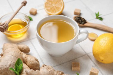 Beyaz fayanslı bir fincan zencefilli çay ve bal.