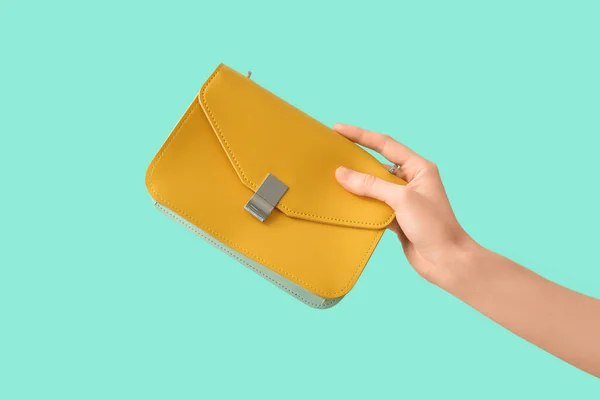 Female Hand Stylish Yellow Bag Turquoise Background — Stock Photo, Image