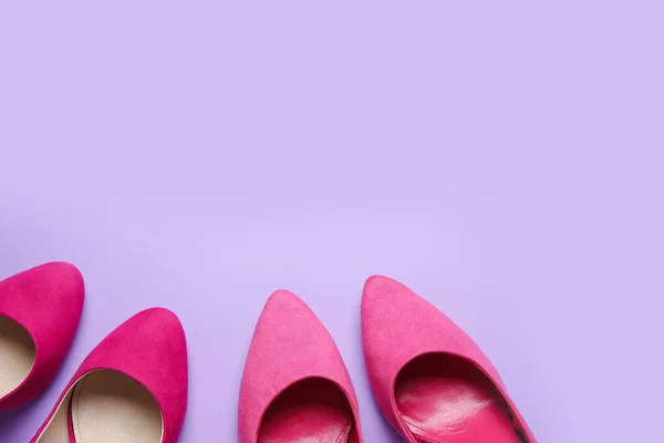 Stylish pink high heels on lilac background