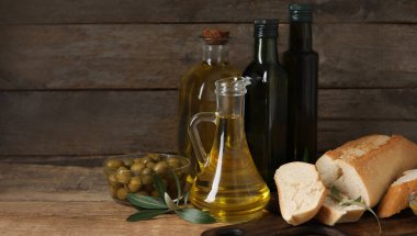 Sağlıklı zeytinyağı ve ahşap zemin üzerinde taze ekmek.