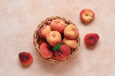 İncirli şeftalili hasır kase ve pembe arka planda nane şekeri