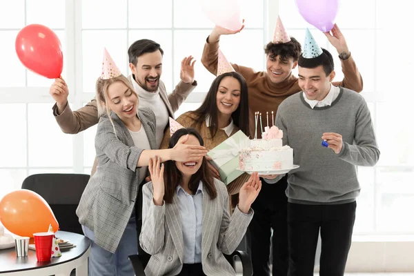 在办公室的聚会上 一群生意人用生日蛋糕让同事大吃一惊 — 图库照片