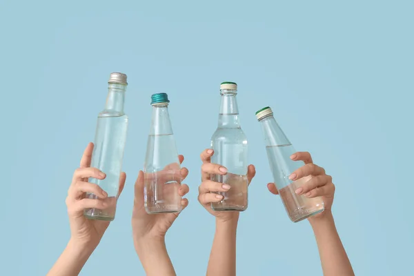 Female Hands Bottles Cold Water Blue Background — Stock Photo, Image