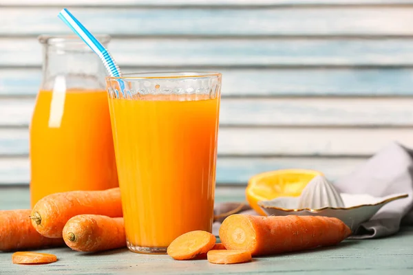 Glass Bottle Fresh Carrot Juice Orange Blue Wooden Table — Stock Photo, Image