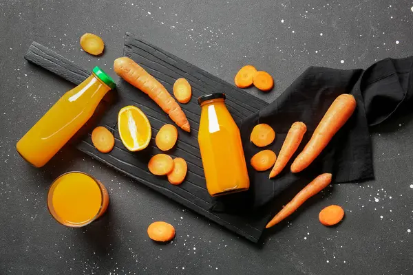 Board Bottles Glass Fresh Carrot Juice Black Background — Stock Photo, Image